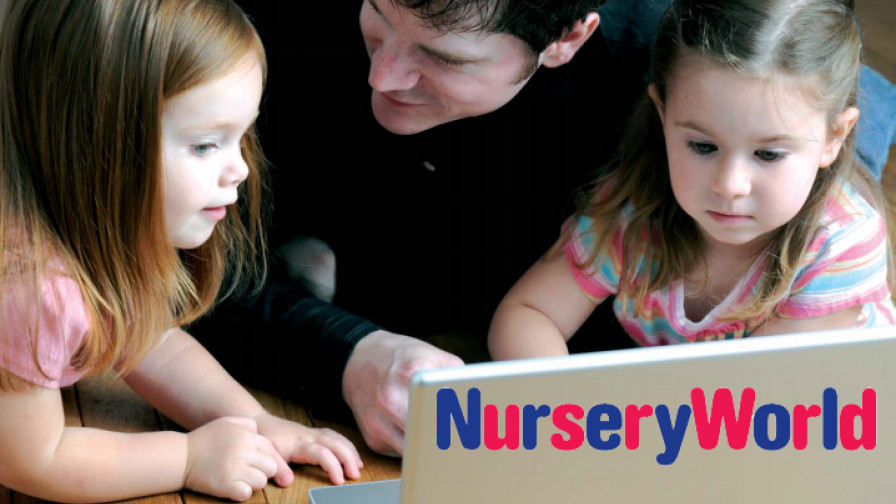 Dad and two young daughters using a laptop