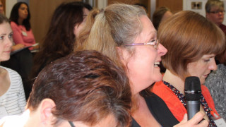 An audience member at the 2016 NAFIS Conference speaks with a microphone