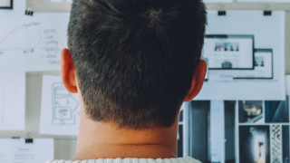 Man looking at board with notes