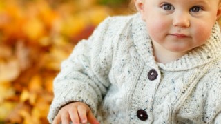 baby and autumn leaves