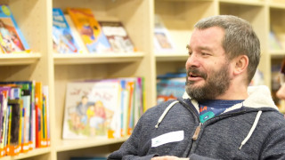 Parent champion speaking at a meeting in a library