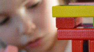 child playing with building blocks