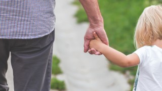 child walking holding hands with elder