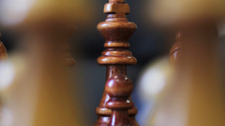 Close up of the King chess piece on a chess board