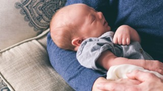 young baby in father's arms